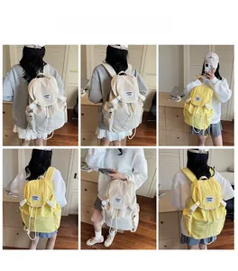 Detail view of stylish cream and yellow canvas backpacks shown by a model for daily use