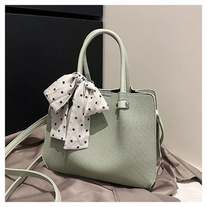 Détail du sac cabas tissé vert sauge avec foulard à pois et fine bandoulière