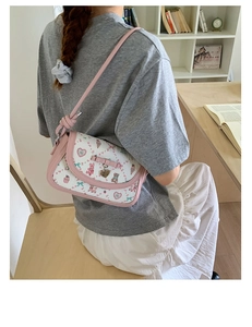 Detail of pink bow and cartoon animal print on a sweet style girls shoulder bag