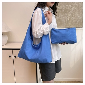 Detail shot of Klein blue canvas tote and matching clutch bag in a modern interior