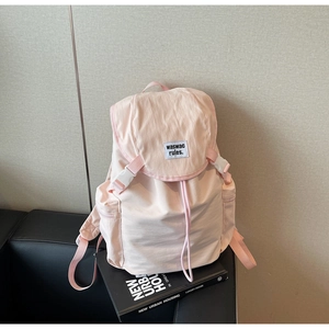 Light pink canvas backpack detail with drawstring closure and flip cover design