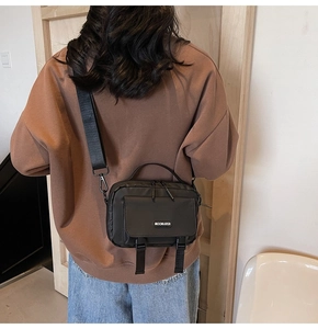 Detail of waterproof nylon crossbody bag with flap pocket and adjustable straps