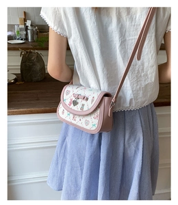 Detail of pink and white crossbody bag with cute bear prints and a 3D bow decoration