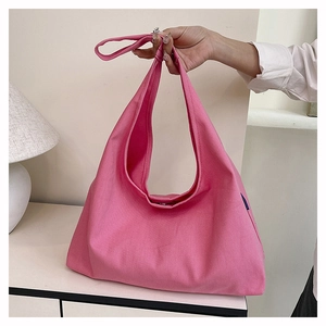 Detail of soft pink canvas tote bag showing thick durable fabric and relaxed drape texture