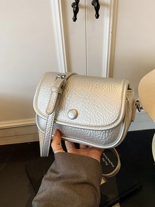 Chic silver litchi grain square crossbody bag with round buckle shown in hand
