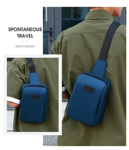Detail of a navy blue sporty chest bag with water-repellent fabric and metal buckle adjustment