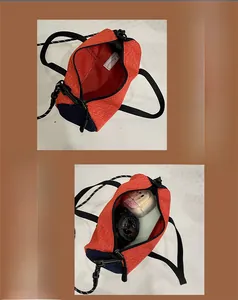 Detail view showing internal storage capacity of the orange and navy sports crossbody bag