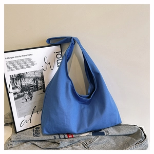 Detail shot of the spacious Klein blue canvas hobo bag showing wide shoulder strap texture