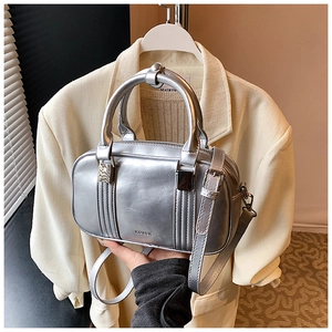 Detail of silver metallic Boston bag showing the dual handles and Rosek embossed logo