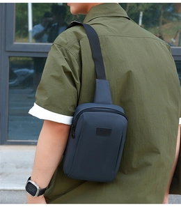 Detail of waterproof crossbody chest bag with embossed SPORT logo and adjustable strap