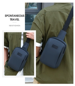 Detail of grey-blue waterproof sling bag with matte finish and top zipper for men