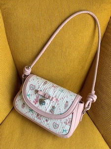 Pink ballet-style crossbody bag with floral teddy bear prints and a decorative bow