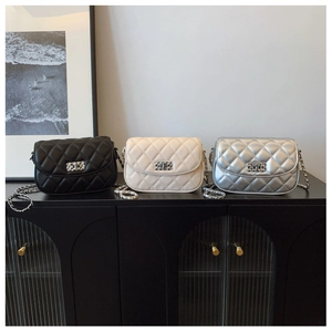 Detailed view of quilted chain bags in black, beige and silver with metal twist locks