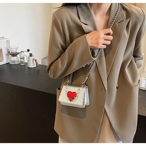 Chic silver mini crossbody bag with red heart accent and scalloped edge detail