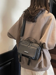Black nylon shoulder messenger bag for men and women with adjustable strap and buckles