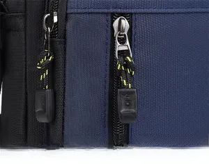 Detail of durable nylon fabric with double metal zippers and yellow cord pullers