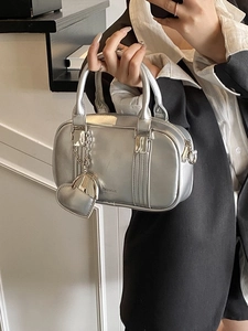 Metallic silver bowling handbag for women with heart charm and crossbody strap