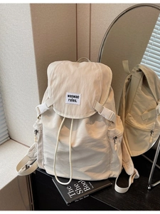 Minimalist beige canvas backpack with drawstring closure and large capacity for travel