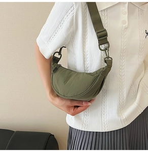 Detailed close-up of olive green nylon crescent bag with adjustable wide shoulder strap