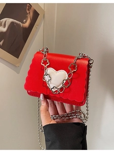 Mini red heart crossbody bag with wavy edge design and silver flower chain strap