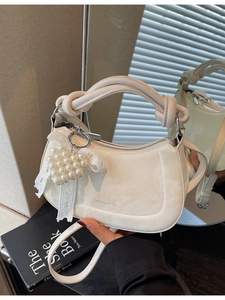 Elegant white crescent hobo bag with knotted handle and heart pearl charm detail