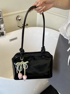 Glossy black patent leather shoulder bag with knot straps and floral pearl charms