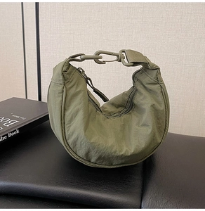 Detail view of military green nylon hobo bag with a durable quick-release plastic buckle