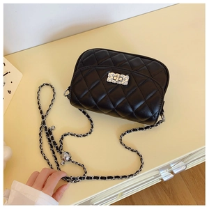 Detail of black quilted leather shoulder bag with silver square twist lock and chain strap