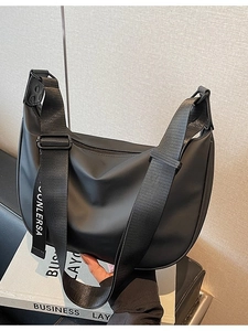 Black nylon crescent crossbody bag featuring adjustable wide strap with white lettering