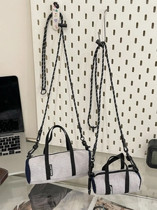 Mini gray canvas sports crossbody bag with blue mesh sides and woven shoulder strap