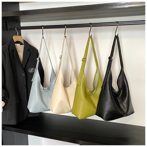 Minimalist hobo bucket bags in blue, beige, green, and black with adjustable straps