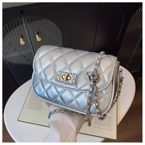 Close-up of metallic silver quilted chain bag with diamond lattice and square twist lock