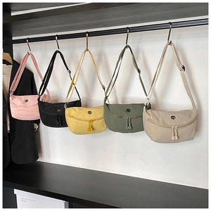 Multi-color nylon crescent crossbody bags hanging on display showing various color options