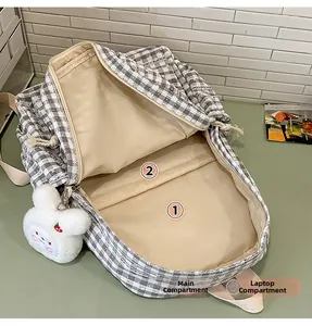 Detail view of plaid backpack interior featuring a main pocket and laptop compartment