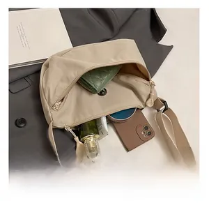 Top view of beige crescent bag showing interior space for phone and wallet essentials