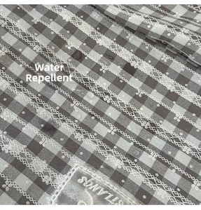 Water-repellent checkered fabric detail with lace trim and elegant embroidery