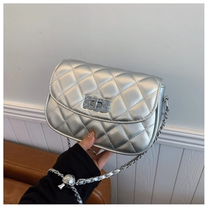 Close-up of silver quilted crossbody bag featuring chain strap and metallic lock