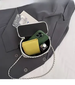 Interior view of white quilted mini bag showing space for phone, wallet and perfume
