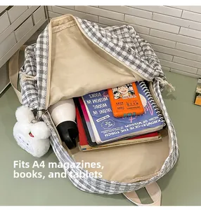 Spacious interior of grey plaid backpack fits A4 magazines, books and tablets