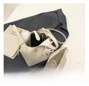 Internal storage layout of cream bucket bag with small pouch and leather texture