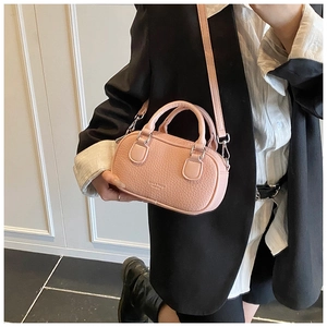 Pink lychee texture bowling bag with LOVE & LUCK gold lettering on model arm