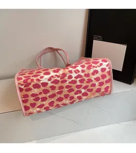 Close-up of pink leopard print canvas tote bag showing base width and stitching detail