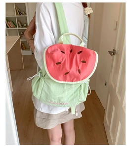 Close-up of cute watermelon backpack with vibrant pink interior and delicate embroidery