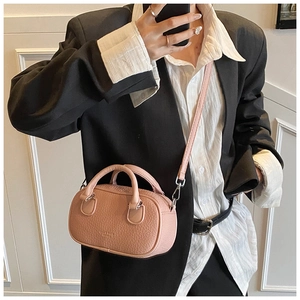 Pink mini bowling bag with lychee texture leather and adjustable crossbody strap