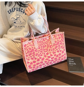 Close-up of a pink leopard print canvas tote bag featuring durable fabric handles