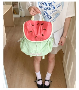 Detail of watermelon canvas backpack with pink and green colors and embroidery
