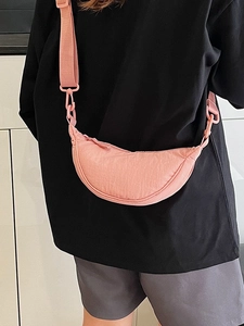 Pink nylon half-moon crossbody bag with adjustable wide strap for casual summer wear