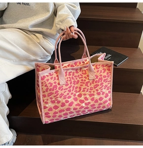 Detail of pink and beige leopard print tote bag on wooden steps with reinforced edges