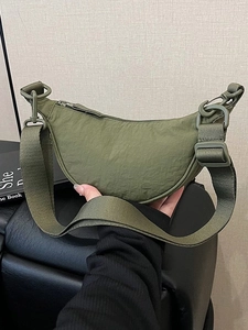 Olive green nylon crescent shoulder bag with adjustable wide strap for casual outdoor use