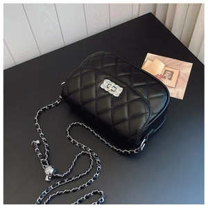 Detail of silver CD logo buckle and black quilted leather on a chain shoulder bag